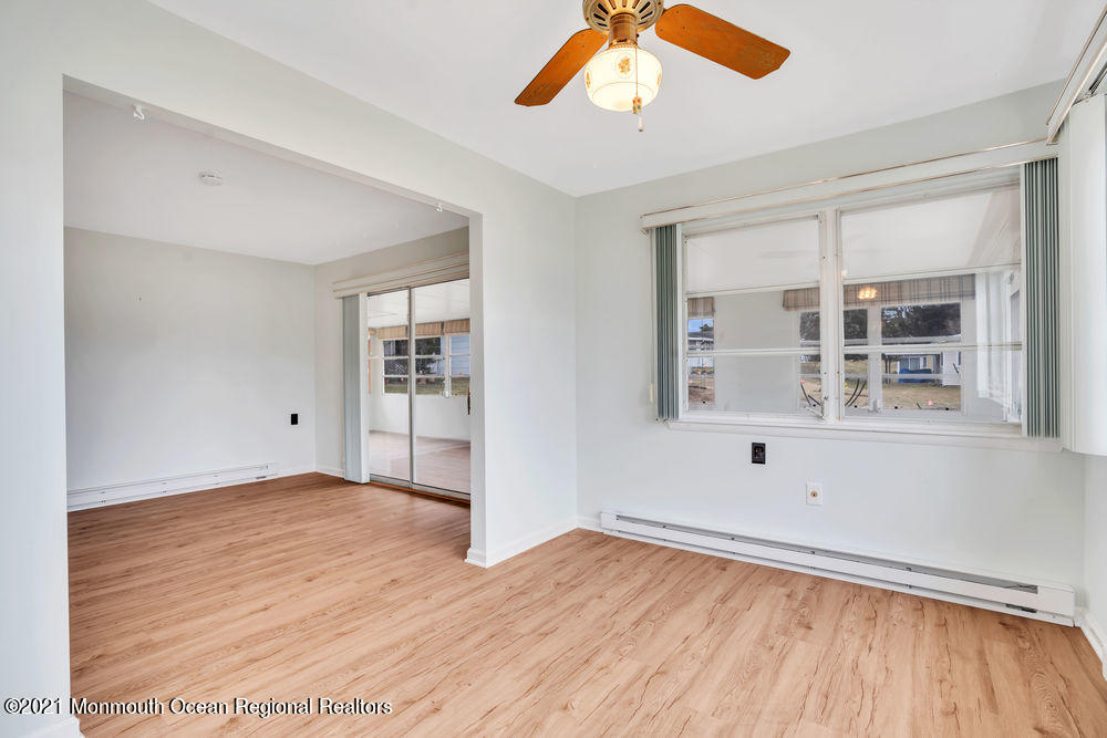 54 Markham Road Brick, NJ 08724 - Photo 15 of 35 an empty room with wooden floor and windows
