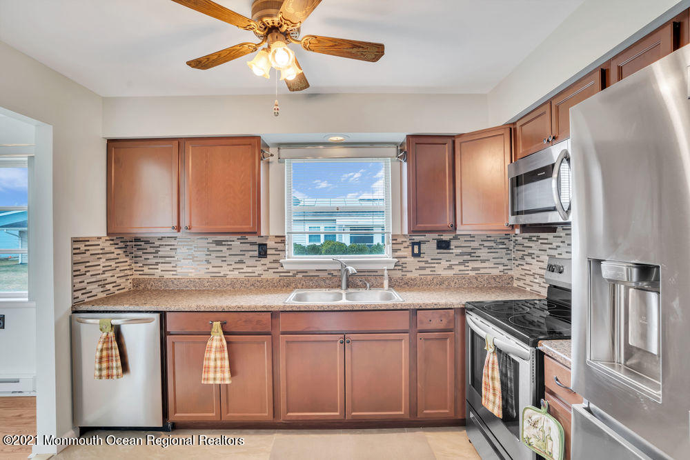 54 Markham Road Brick, NJ 08724 - Photo 21 of 35 a kitchen with stainless steel appliances granite countertop a sink and a refrigerator