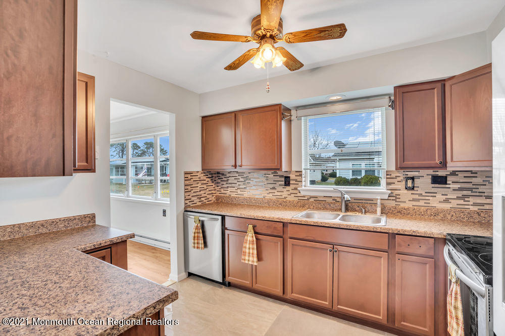 54 Markham Road Brick, NJ 08724 - Photo 22 of 35 a kitchen with kitchen island granite countertop a sink a stove and cabinets