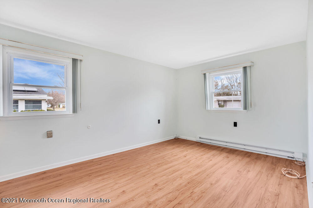 54 Markham Road Brick, NJ 08724 - Photo 28 of 35 a view of an empty room with wooden floor and a window