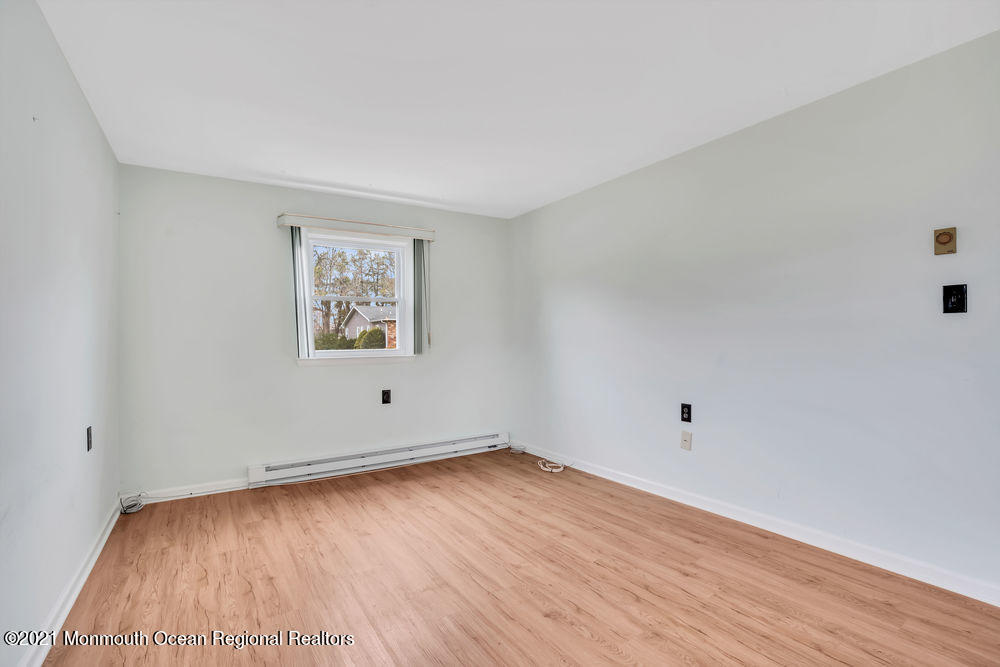 54 Markham Road Brick, NJ 08724 - Photo 31 of 35 an empty room with wooden floor and windows