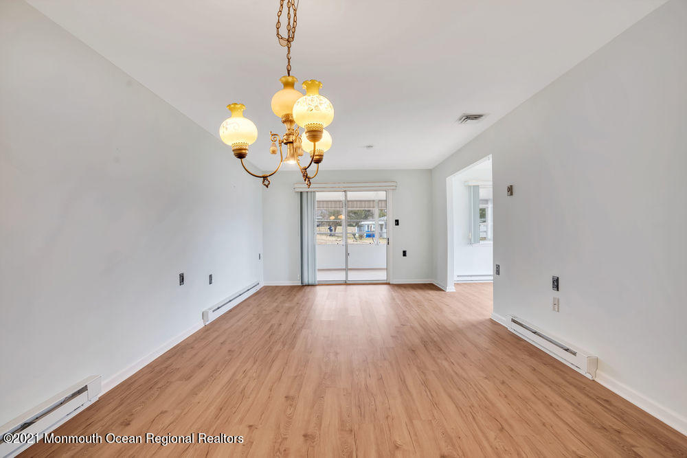 54 Markham Road Brick, NJ 08724 - Photo 6 of 35 a view of an empty room with wooden floor and a window