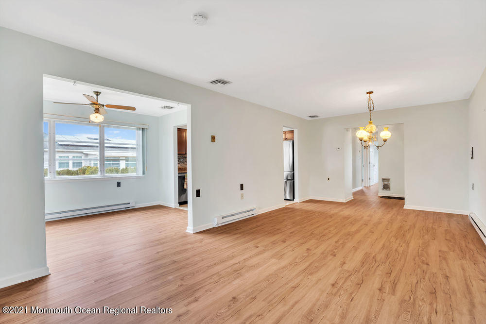 54 Markham Road Brick, NJ 08724 - Photo 9 of 35 a big room with wooden floor chandelier and windows