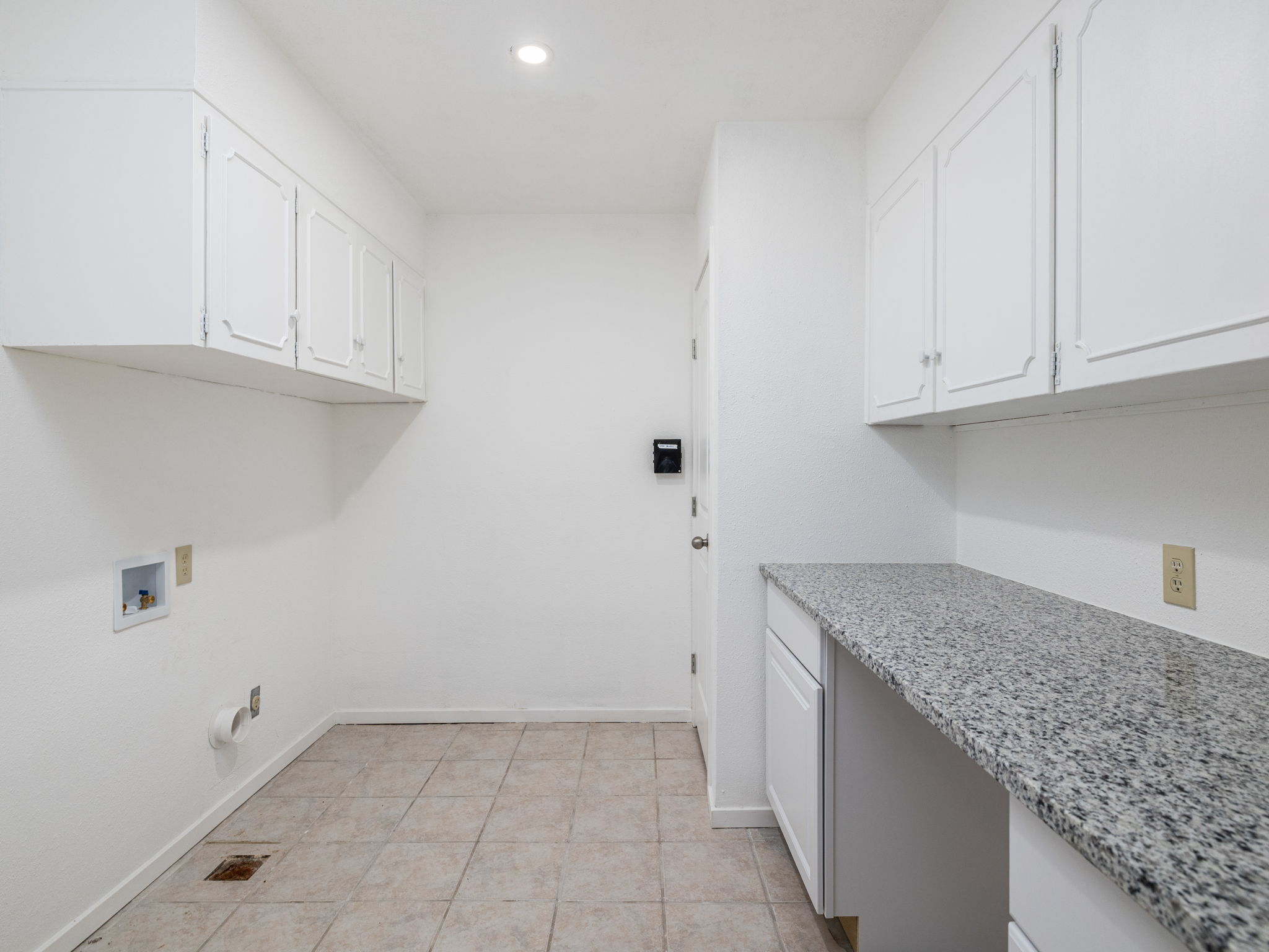 806 Country Club Road Georgetown, TX 78628 - Photo 34 of 39 Completely remodeled laundry room with cabinets and a folding counter