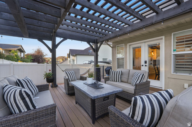 14738 Tangle Hill Road Herriman, UT 84096 - Photo 66 of 66 Expansive wood-finish deck featuring a dark wood pergola and string lighting