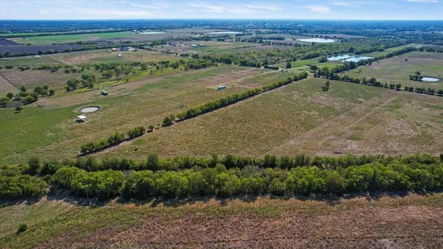 an aerial view of a houses with outdoor space and street