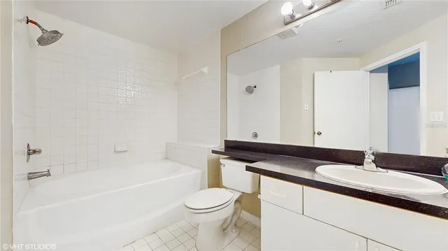 a bathroom with a bathtub a sink a toilet and a mirror