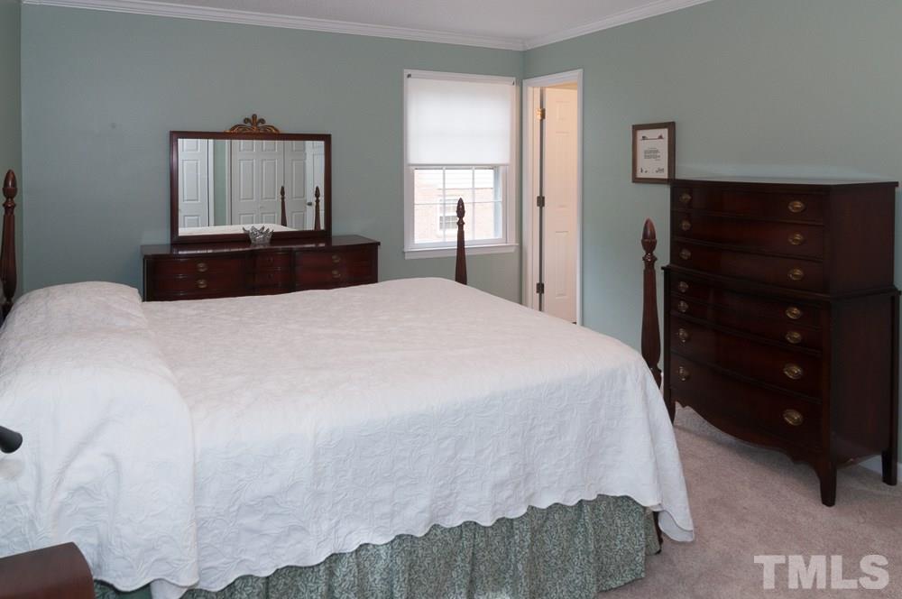 1445 Princess Anne Road Raleigh, NC 27607 - Photo 11 of 25 a bedroom with a bed and a dresser