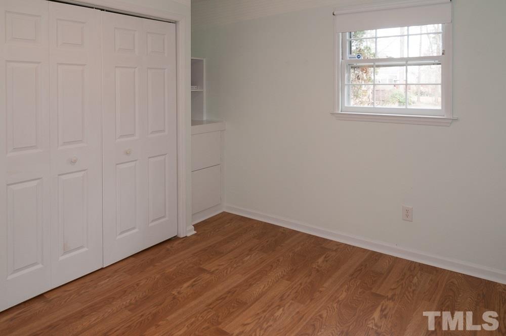 1445 Princess Anne Road Raleigh, NC 27607 - Photo 17 of 25 an empty room with wooden floor and windows
