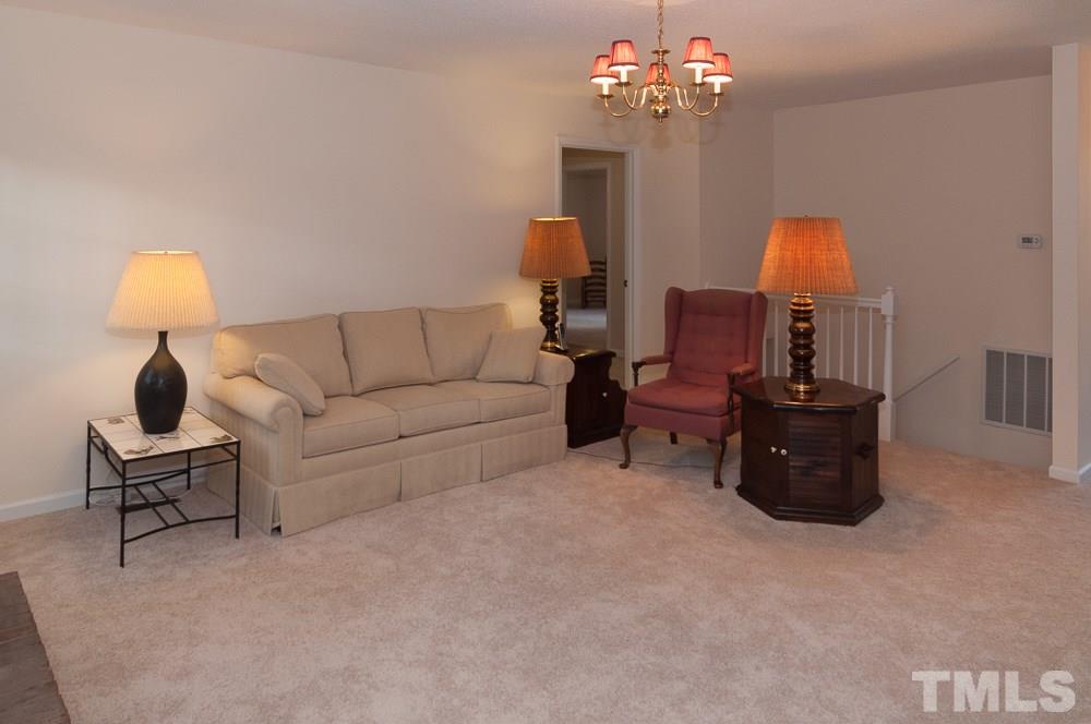 1445 Princess Anne Road Raleigh, NC 27607 - Photo 20 of 25 a living room with furniture and a chandelier