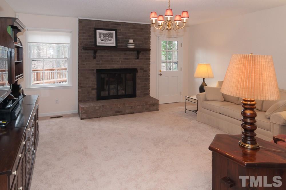 1445 Princess Anne Road Raleigh, NC 27607 - Photo 2 of 25 a living room with furniture a fireplace and a flat screen tv
