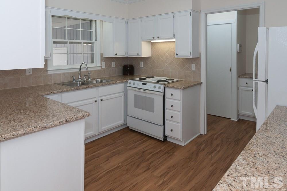 1445 Princess Anne Road Raleigh, NC 27607 - Photo 4 of 25 a kitchen with stainless steel appliances granite countertop a sink stove and refrigerator