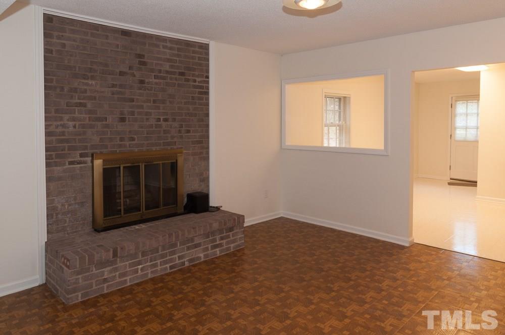 1445 Princess Anne Road Raleigh, NC 27607 - Photo 7 of 25 a living room with a fireplace