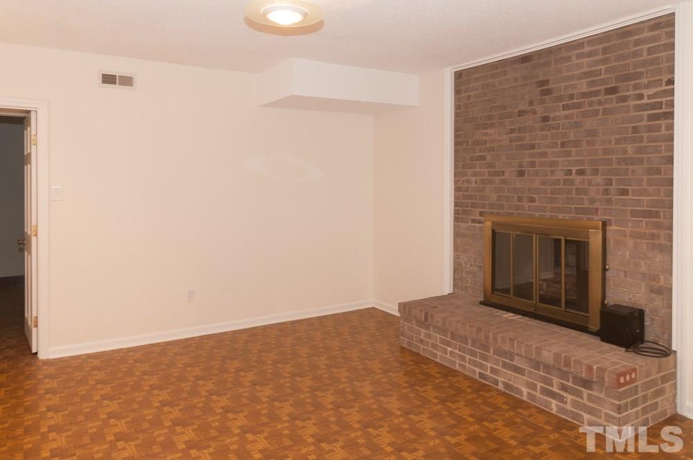 1445 Princess Anne Road Raleigh, NC 27607 - Photo 9 of 25 a view of empty room with a fireplace