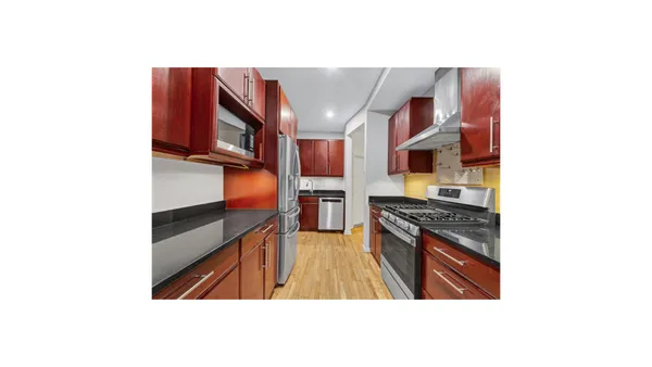 a kitchen with stainless steel appliances granite countertop a stove and a refrigerator