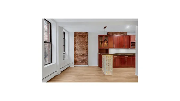 a open kitchen with granite countertop a sink and a refrigerator