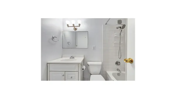 a bathroom with a sink a mirror and a toilet