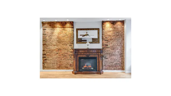 a view of an empty room with fireplace