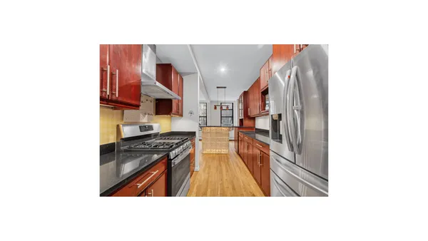 a kitchen with stainless steel appliances granite countertop a refrigerator and a stove