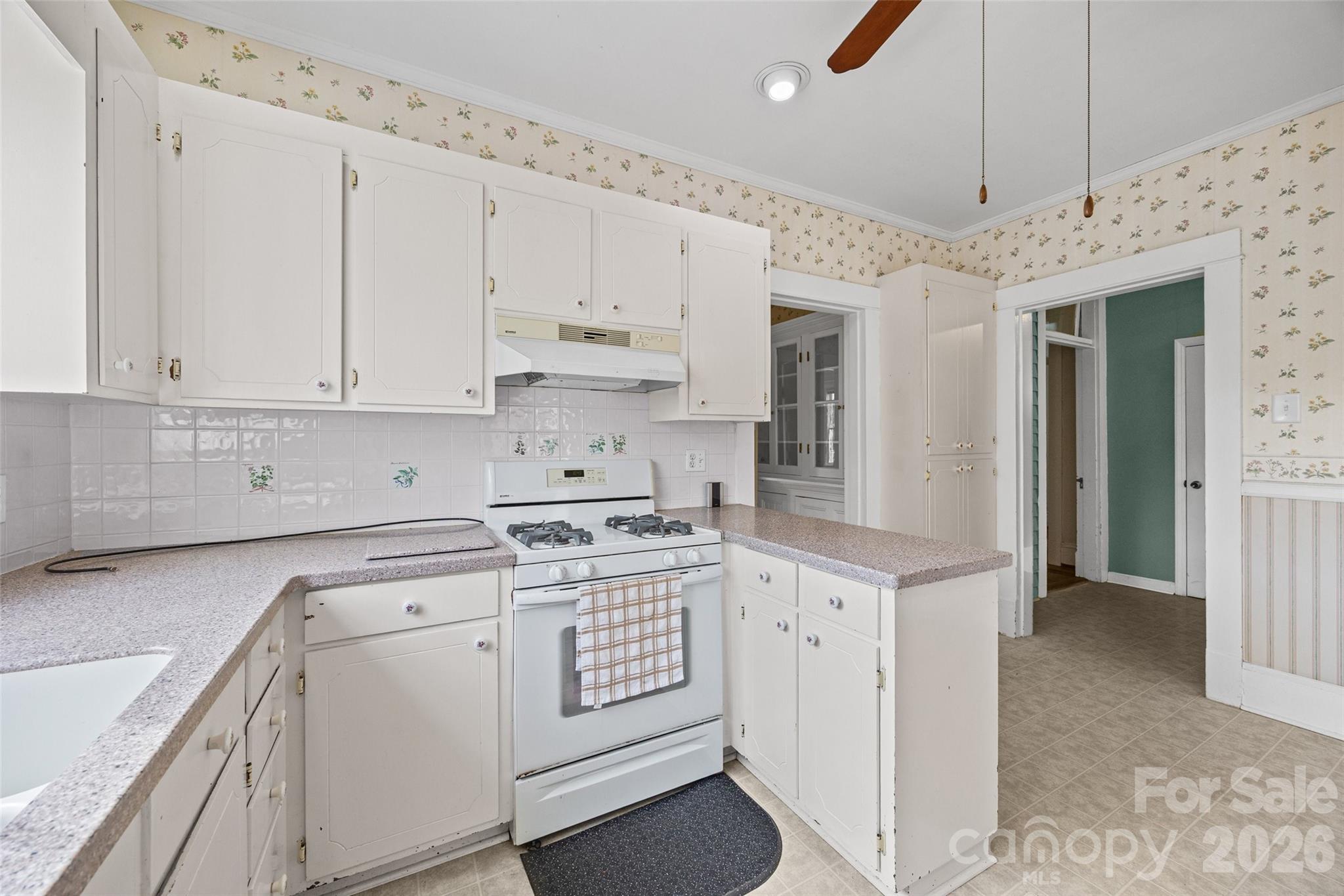 202 Pressley Street Clover, SC 29710 - Photo 17 of 26 a kitchen with granite countertop a white stove top oven and white cabinets