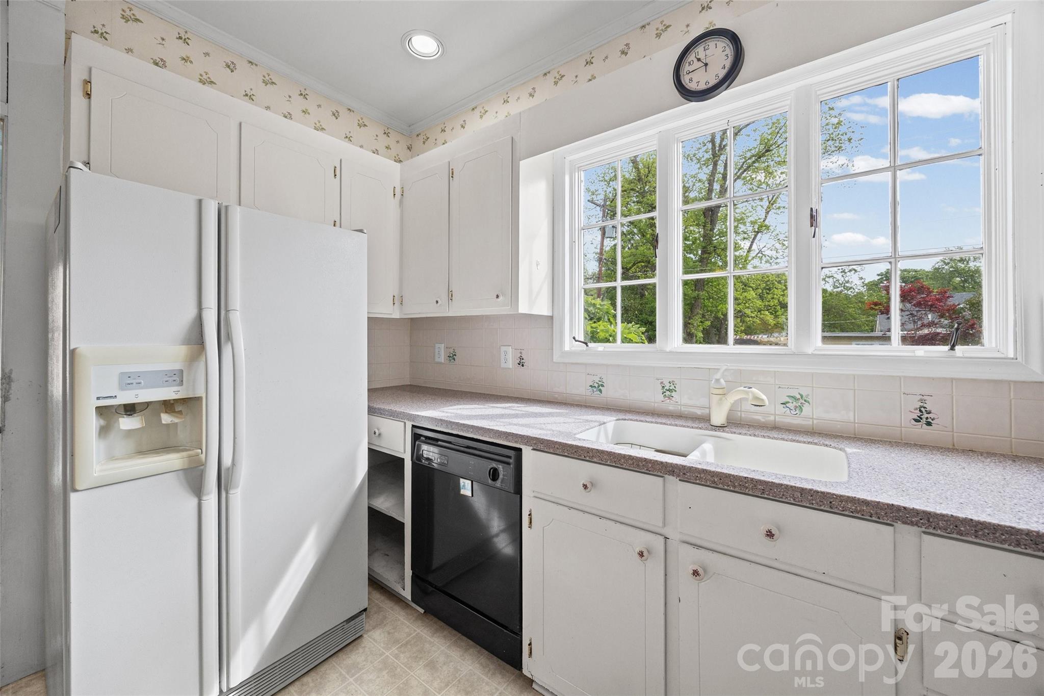 202 Pressley Street Clover, SC 29710 - Photo 18 of 26 a kitchen with a sink a large window stainless steel appliances and cabinets
