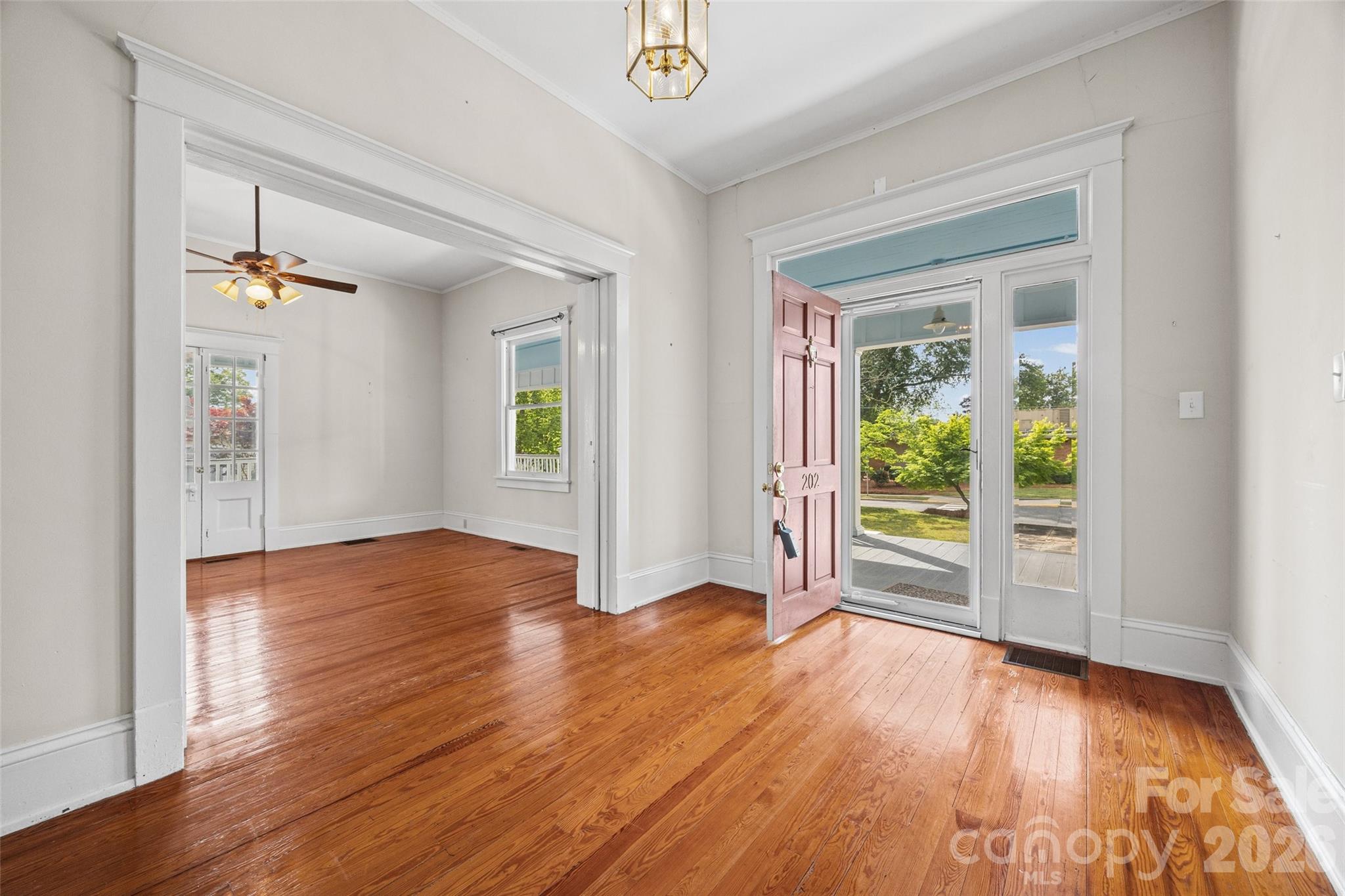 202 Pressley Street Clover, SC 29710 - Photo 3 of 26 an empty room with wooden floor and windows