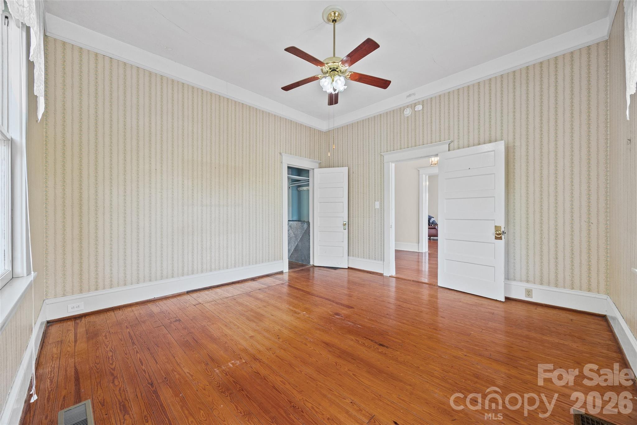 202 Pressley Street Clover, SC 29710 - Photo 4 of 26 an empty room with wooden floor and ceiling fan