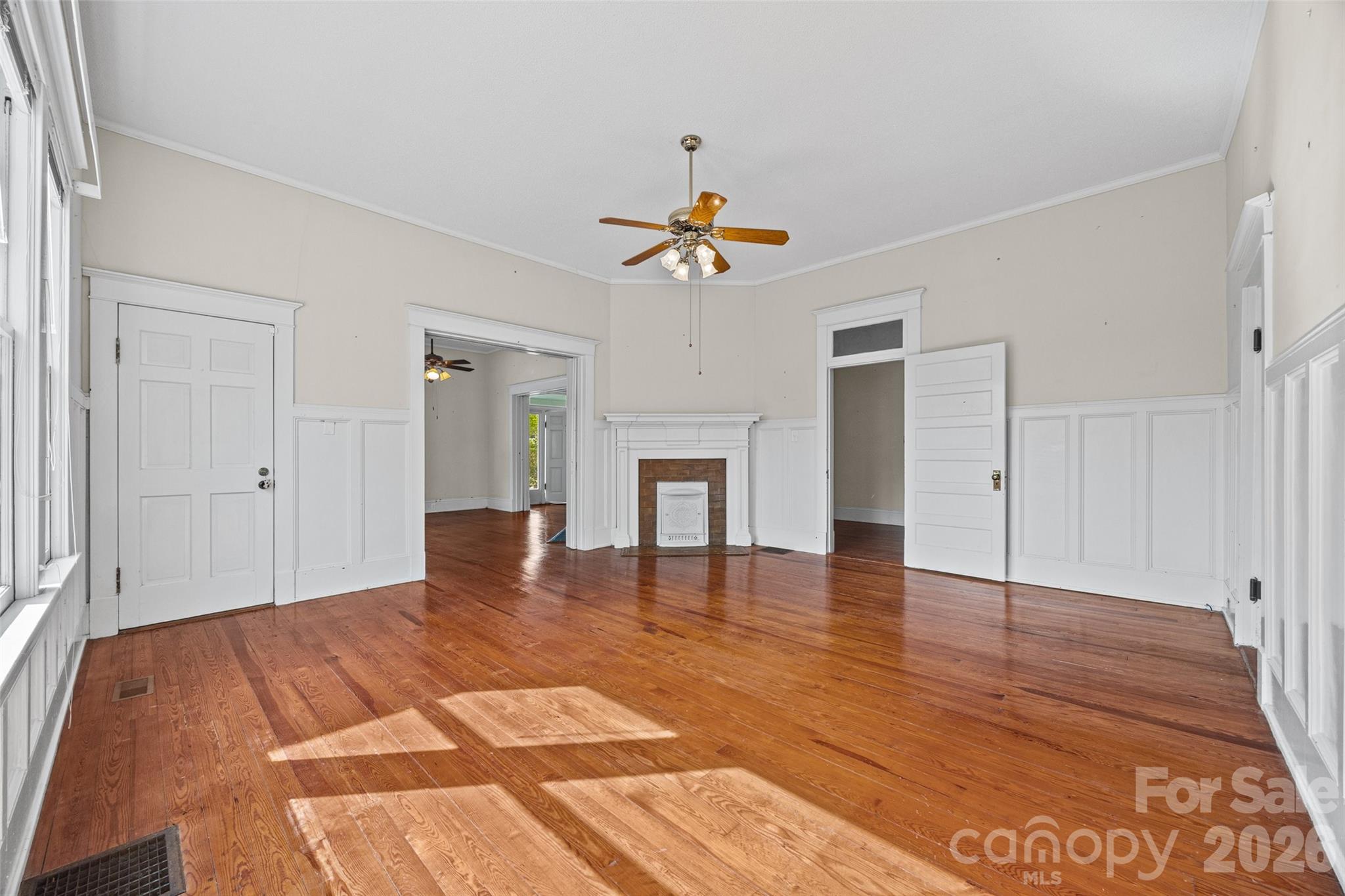 202 Pressley Street Clover, SC 29710 - Photo 6 of 26 a view of an empty room with window and wooden floor