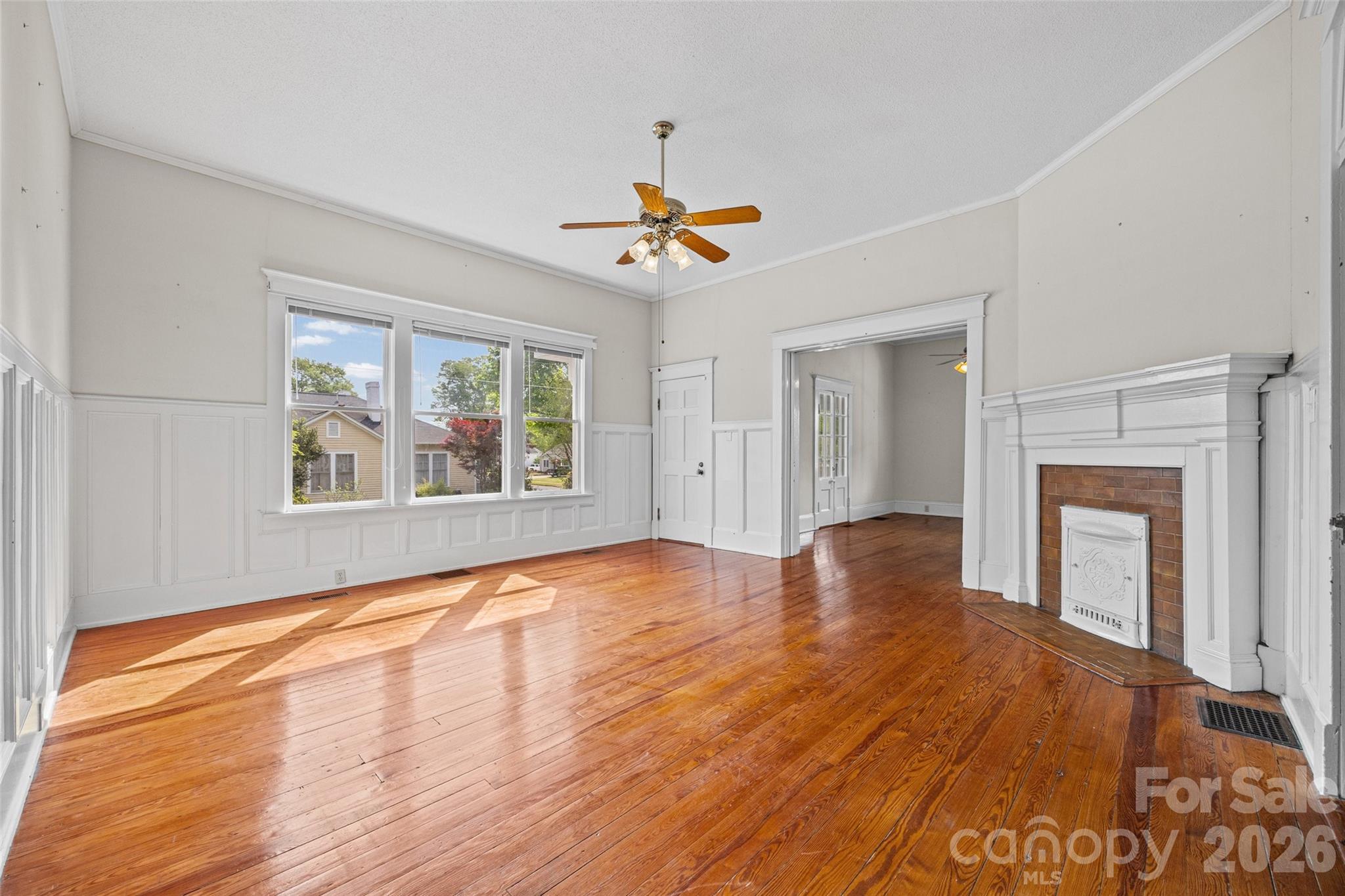 202 Pressley Street Clover, SC 29710 - Photo 7 of 26 a view of an empty room with window and wooden floor