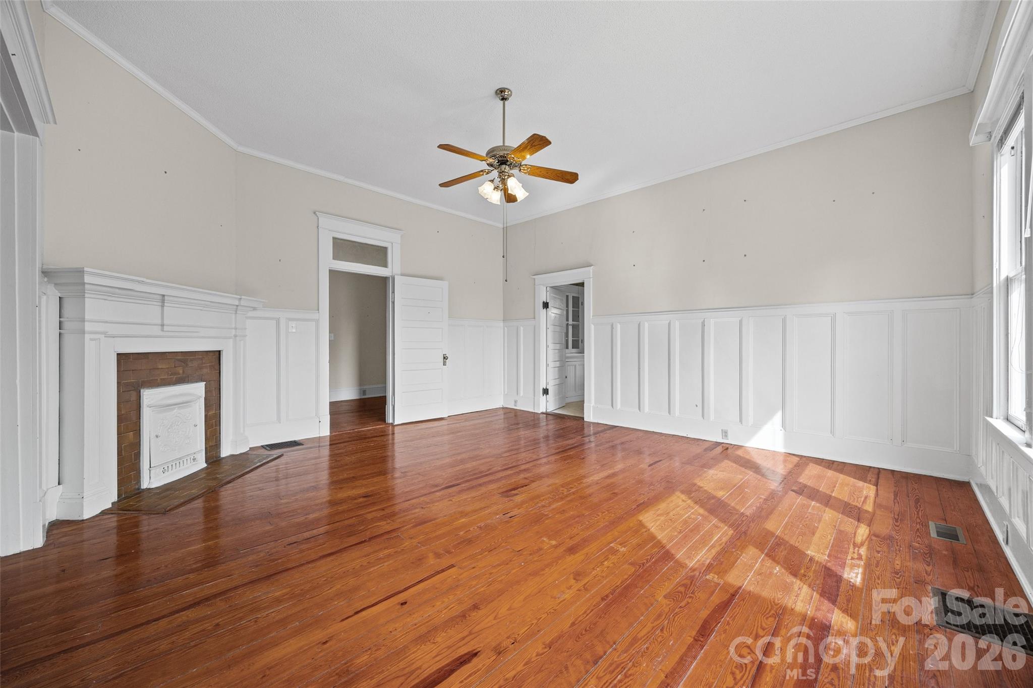 202 Pressley Street Clover, SC 29710 - Photo 8 of 26 a view of an empty room with window and wooden floor