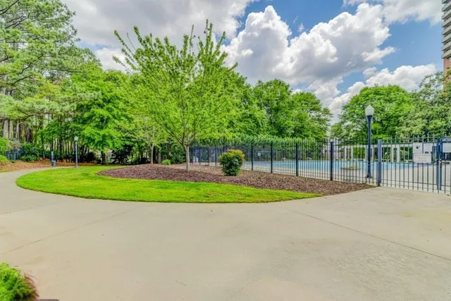 a sign that is sitting in front of flowers