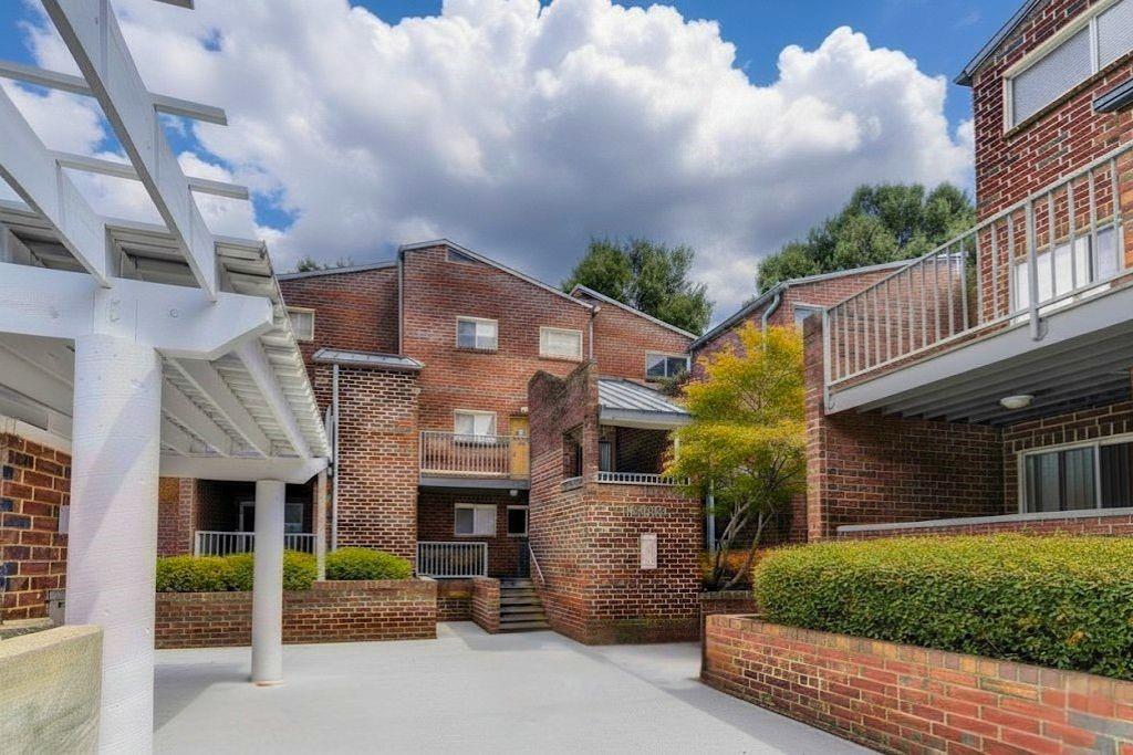 381 Ralph McGill Boulevard Northeast, Unit E Atlanta, GA 30312 - Photo 19 of 27 a front view of a house with a garden