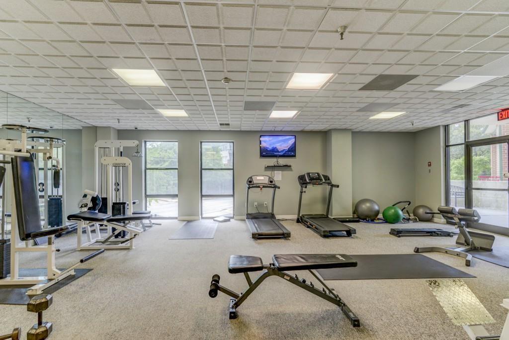 381 Ralph McGill Boulevard Northeast, Unit E Atlanta, GA 30312 - Photo 21 of 27 a room with gym equipment and windows