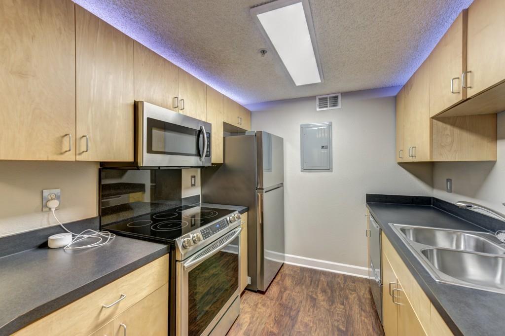 381 Ralph McGill Boulevard Northeast, Unit E Atlanta, GA 30312 - Photo 3 of 27 a kitchen with kitchen island granite countertop a sink stove and refrigerator