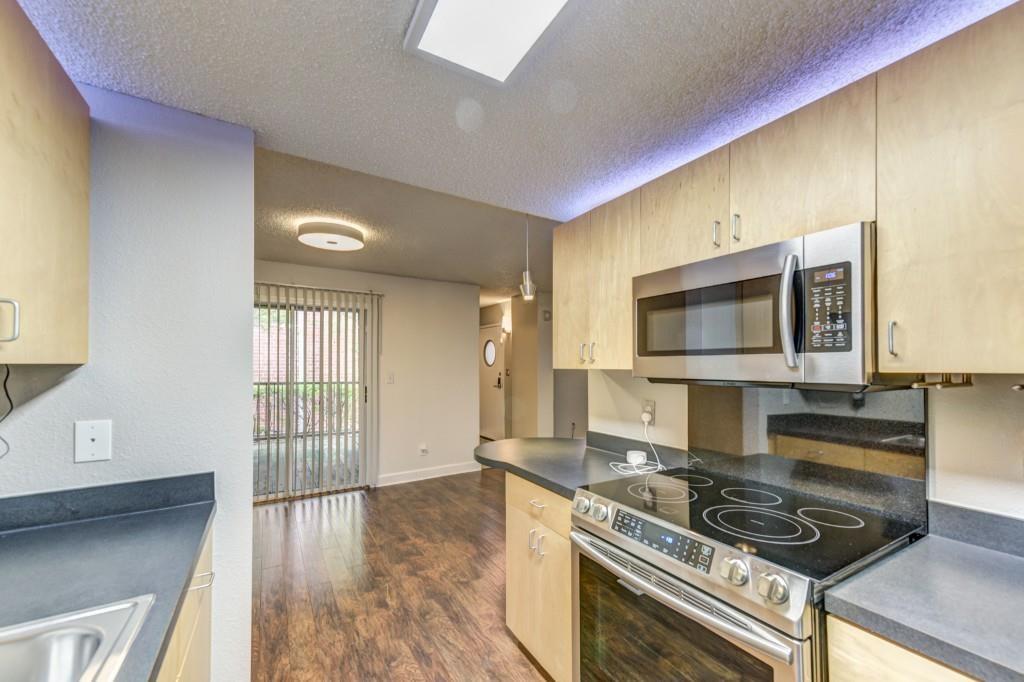 381 Ralph McGill Boulevard Northeast, Unit E Atlanta, GA 30312 - Photo 4 of 27 a kitchen with a stove and a microwave