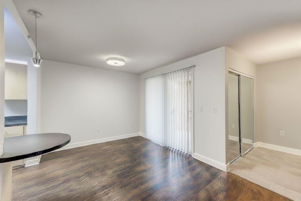 381 Ralph McGill Boulevard Northeast, Unit E Atlanta, GA 30312 - Photo 6 of 27 an empty room with wooden floor and windows