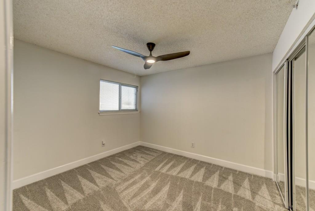 381 Ralph McGill Boulevard Northeast, Unit E Atlanta, GA 30312 - Photo 8 of 27 an empty room with a ceiling fan and window