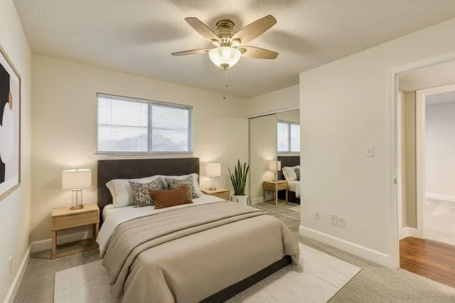 a bedroom with a large bed and a chandelier