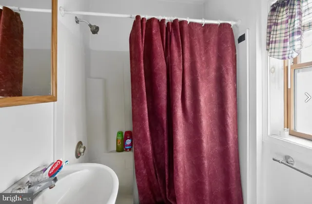 a bathroom with a bathtub and a shower curtain