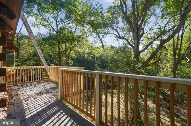 a room with stainless steel appliances kitchen island granite countertop a sink stove and cabinets