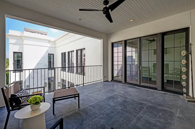a view of a hallway with wooden floor and windows