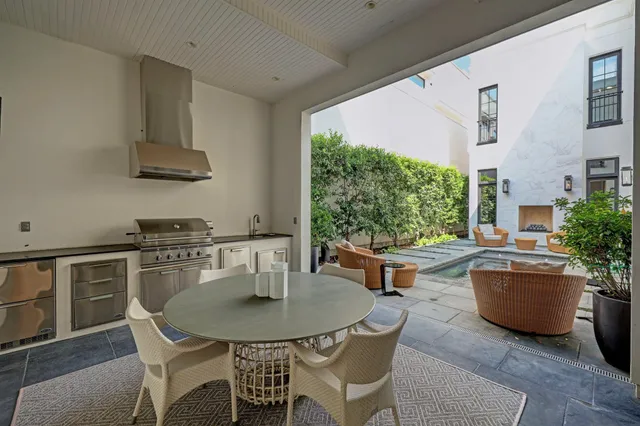 a kitchen with a table chairs stove and cabinets