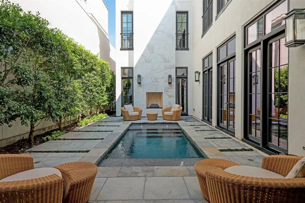 a view of a patio with couches table and chairs and potted plants