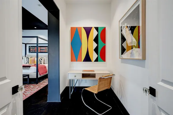 a view of a workspace with furniture and wooden floor