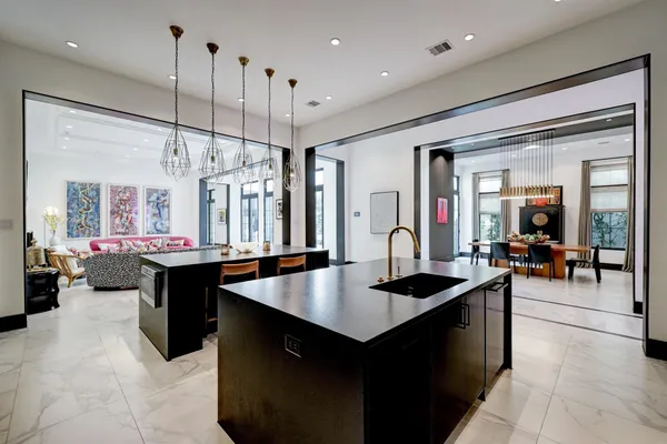 a kitchen with a counter top space a sink appliances and living room