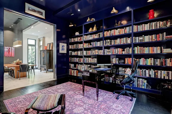 a living room with furniture and a book shelf