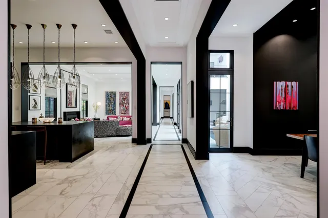 a view of a hallway with couches and a fireplace