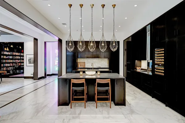 a kitchen with stainless steel appliances granite countertop a stove a refrigerator and a microwave