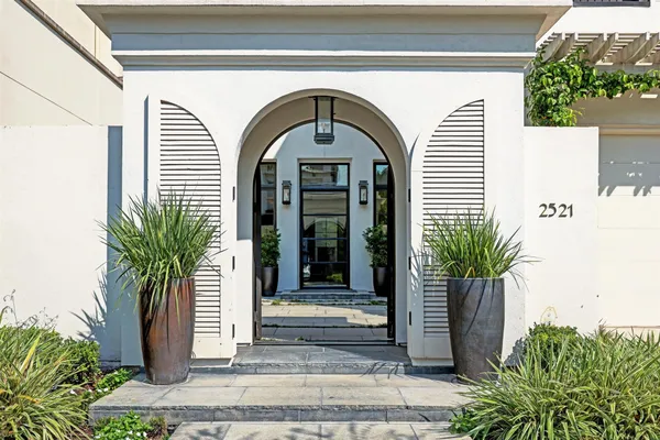 a front view of a house with a garden