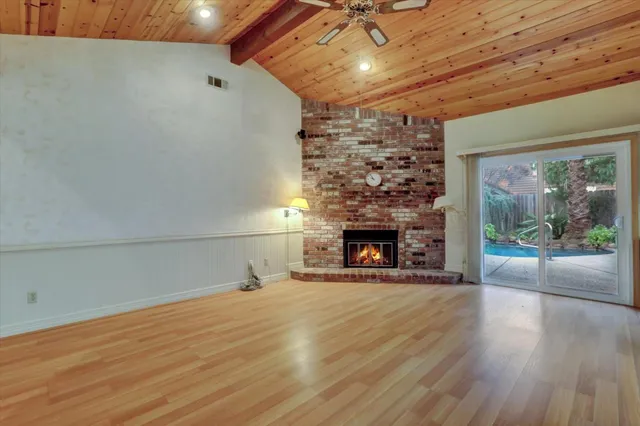 wooden floor in an empty room with a fireplace